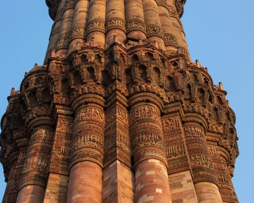 Close-up of Qutub Minar showcasing its intricate architectural details. UNESCO World Heritage Site in Delhi, India.