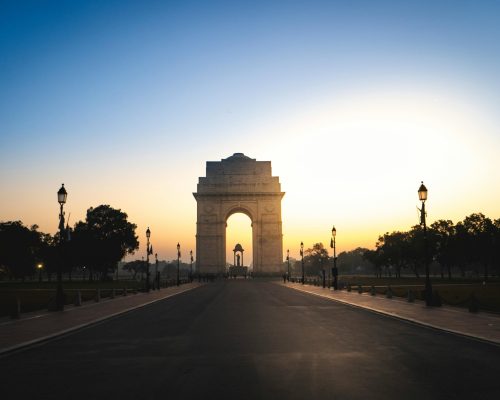 Serene view of the India Gate in New Delhi at dawn, highlighting its architectural beauty and historical significance.